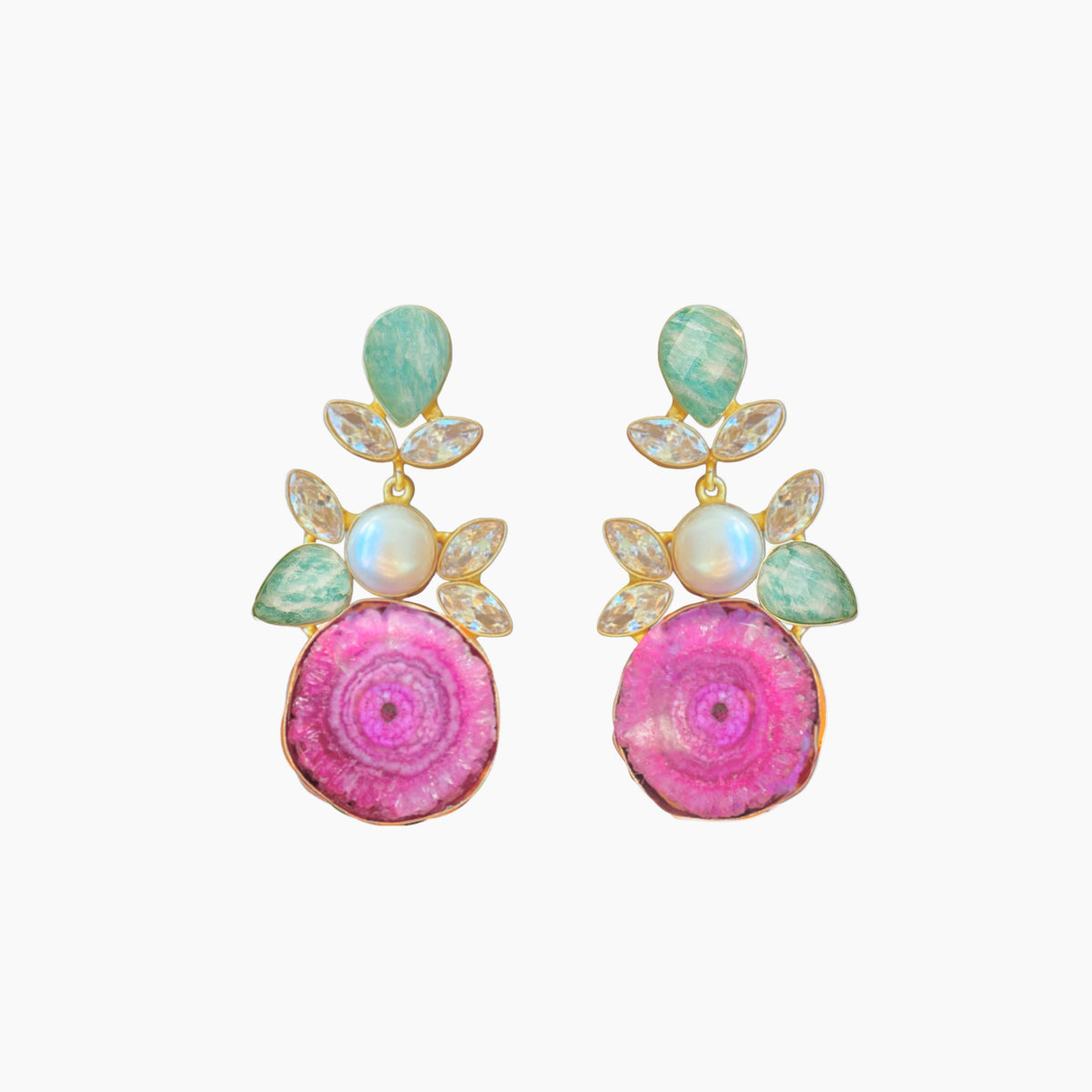 Pair of earrings with pink circular designs and green and gold accents on a white background
