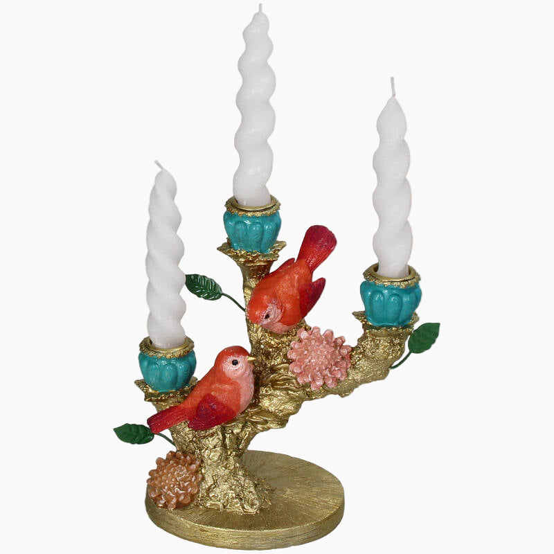 Decorative candle holder with birds and white candles