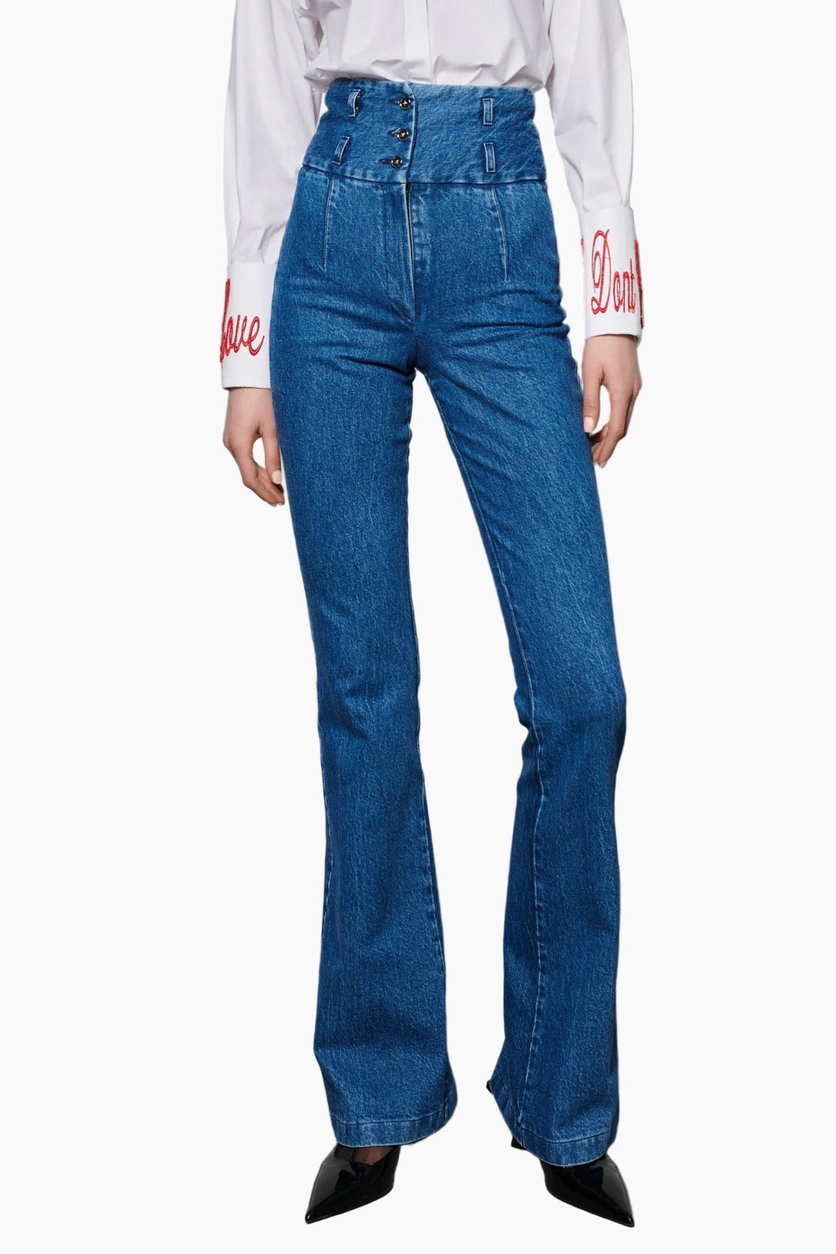 High waist boot cut indigo jeans fit to waist with stretch cotton fabric, detailed with three front buttons and two belt loops.