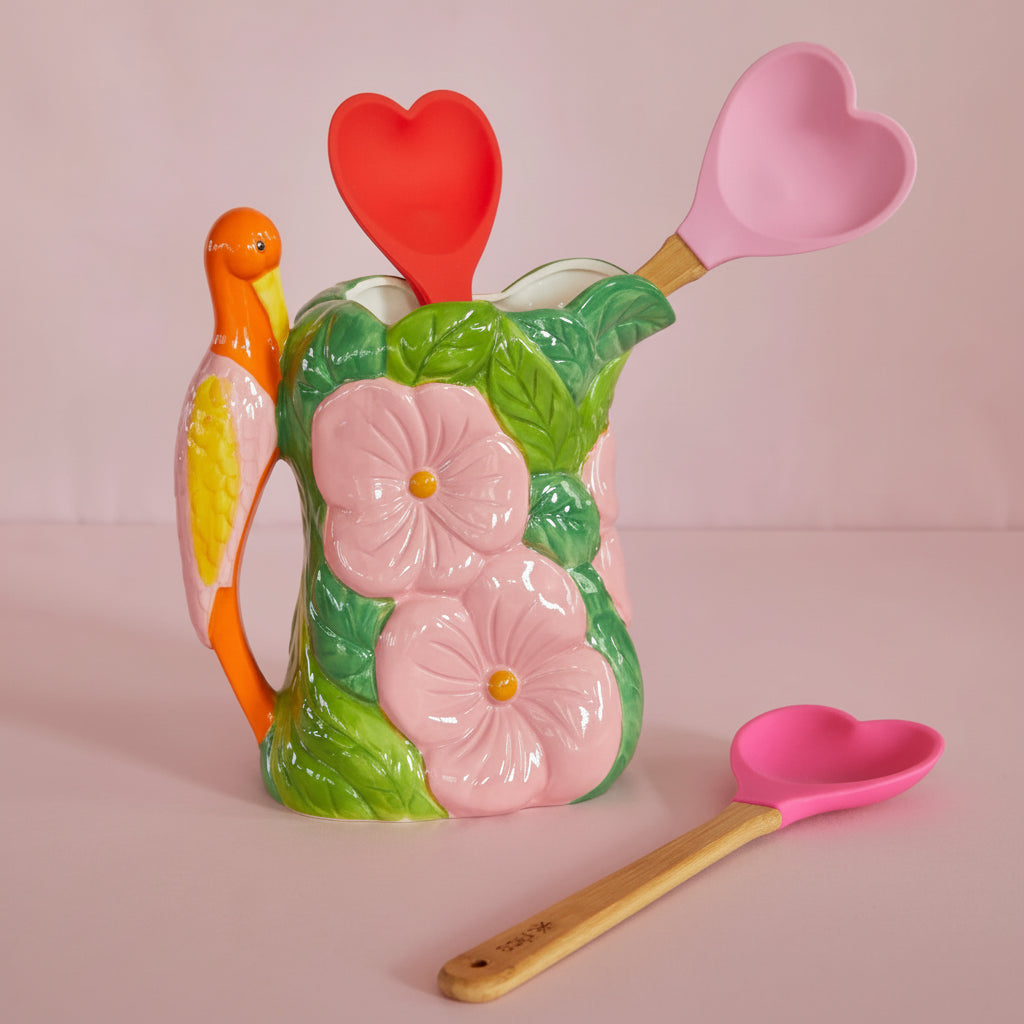 Colorful ceramic cookie jar with floral design and matching heart-shaped spoons