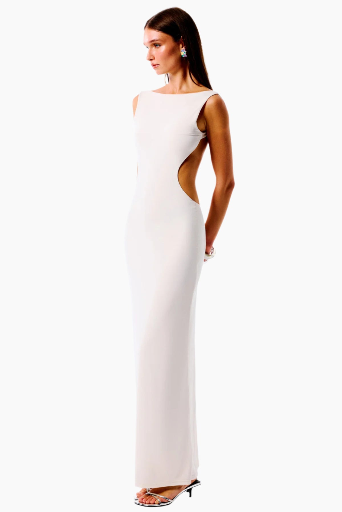 Woman wearing a white evening gown with cut-out design