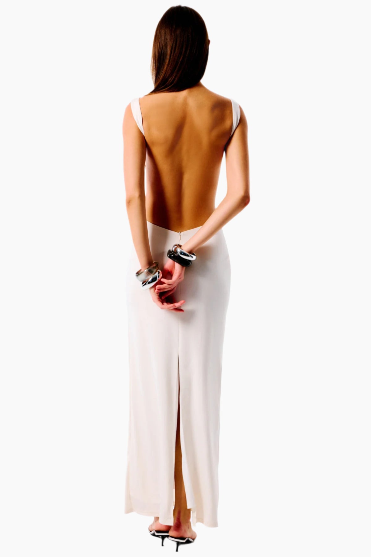 Woman wearing a backless brown top and white skirt