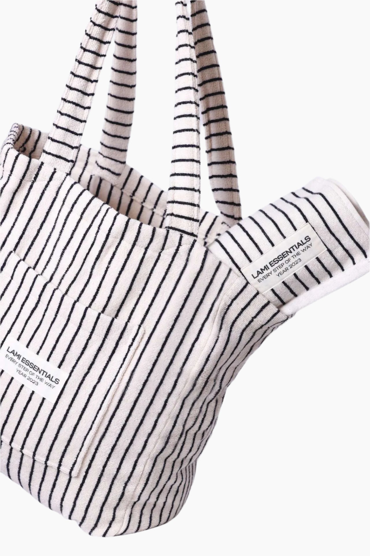 Striped tote bag with the label " lami essentials"