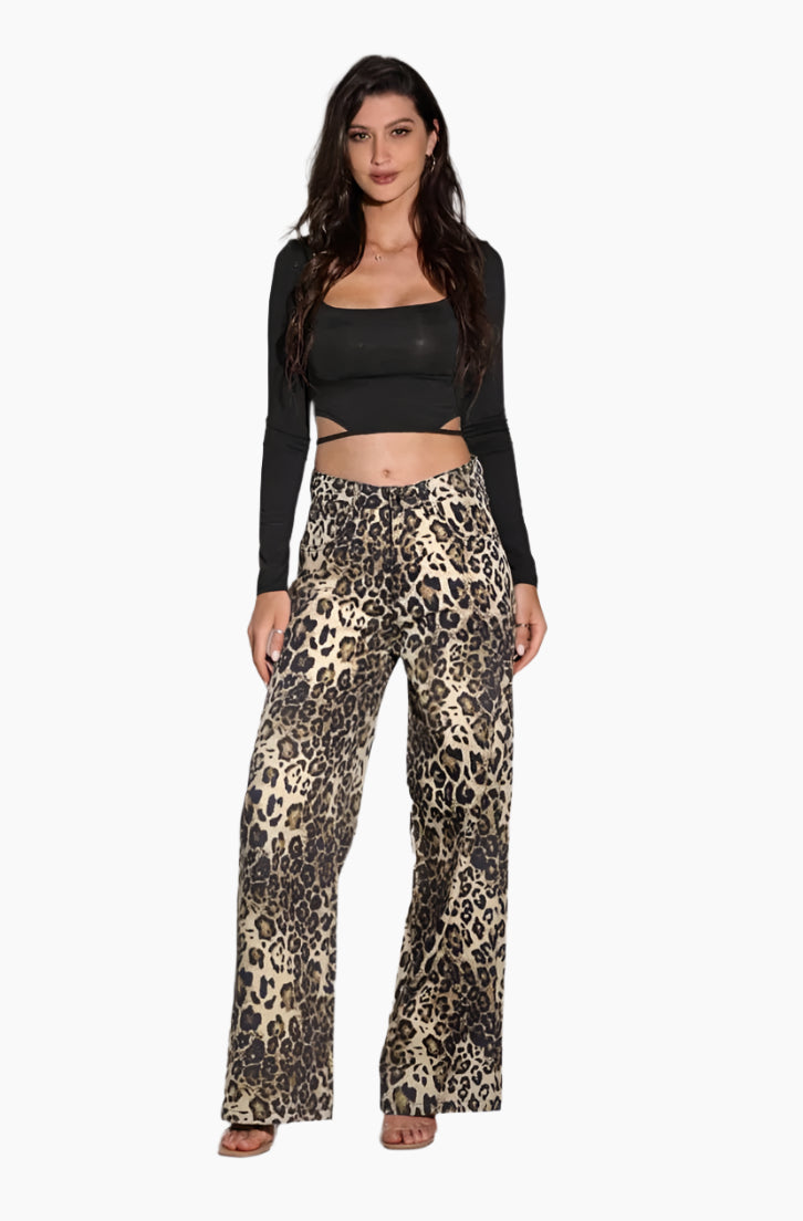 Woman wearing a black long-sleeve top and leopard print pants