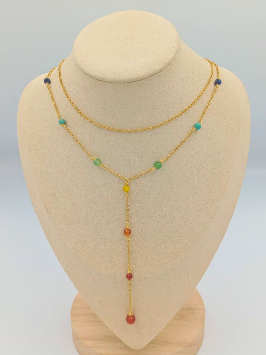 Necklace with colorful beads on a mannequin bust against a light gray background