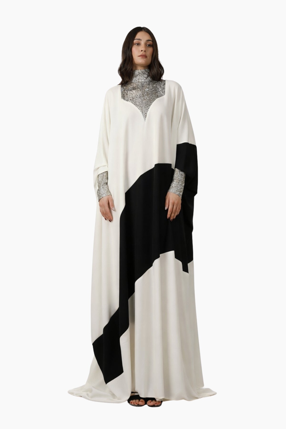 Woman wearing a black and white dress with a high collar on a white background