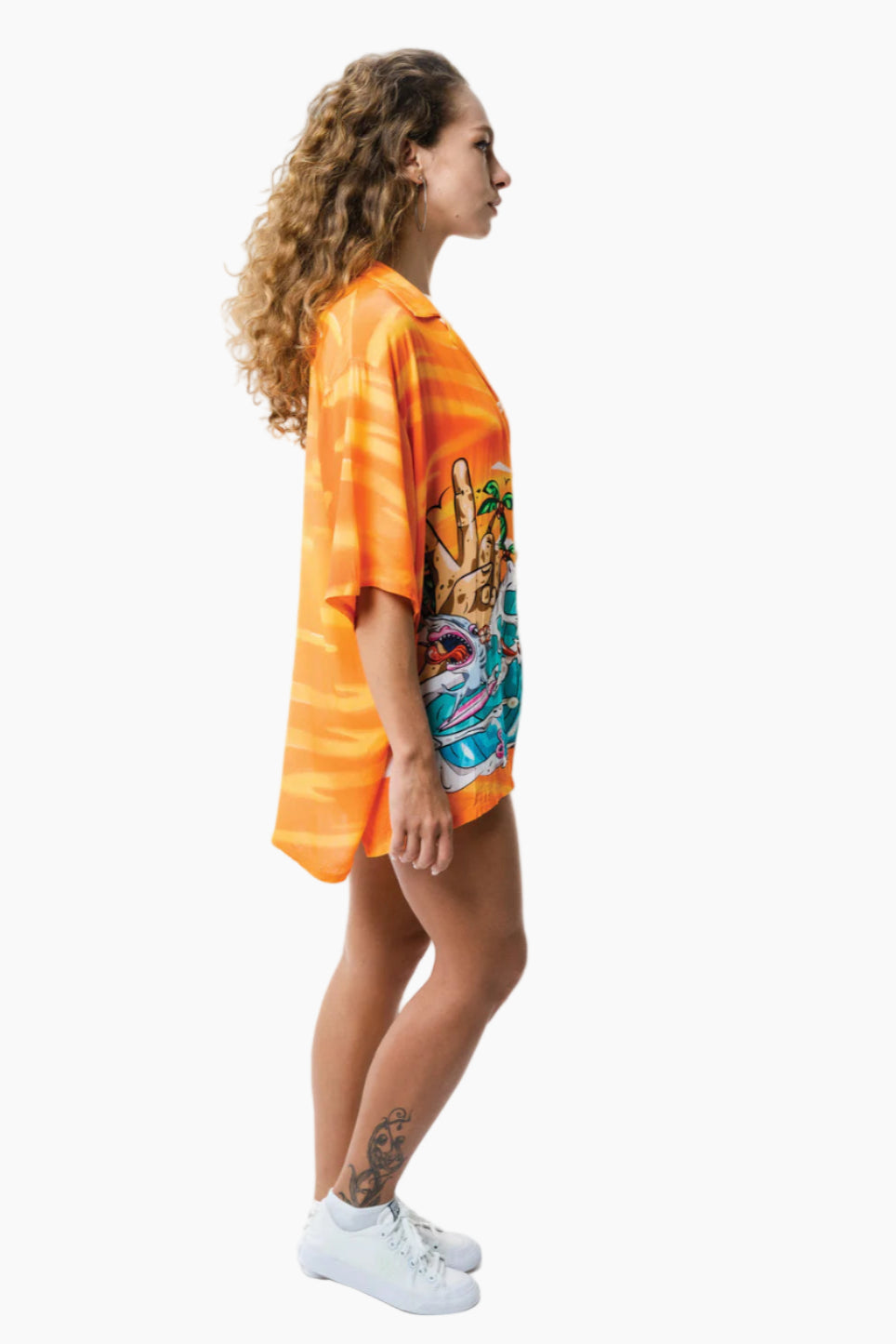 Person wearing an orange tie-dye shirt with a colorful graphic design on a white background
