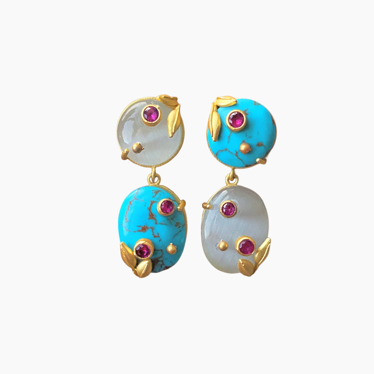 Pair of earrings with turquoise and white stones on a white background