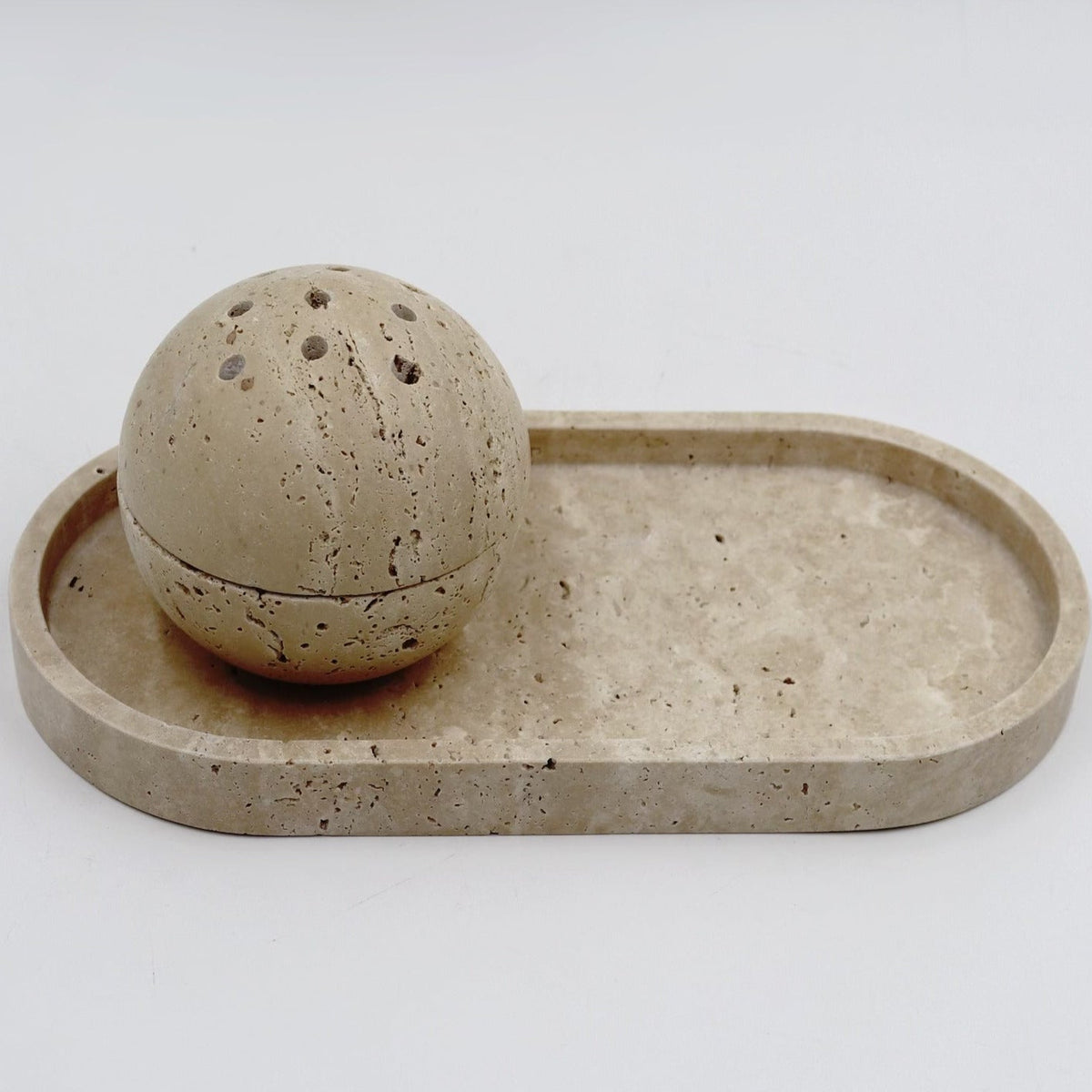 Ceramic sphere and tray on a white background