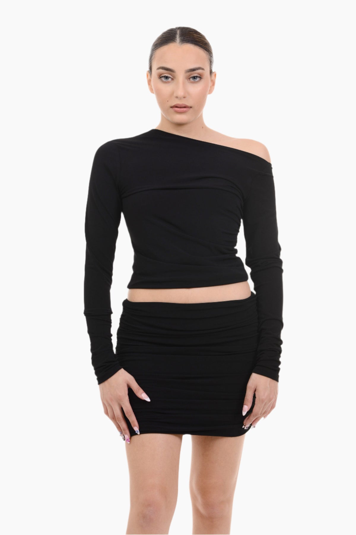 Woman wearing a black off-shoulder top and skirt