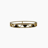 Gold bracelet with black triangle accents