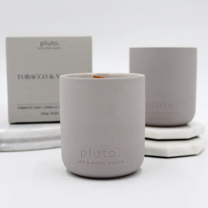 Gray candles with 'pluto' branding