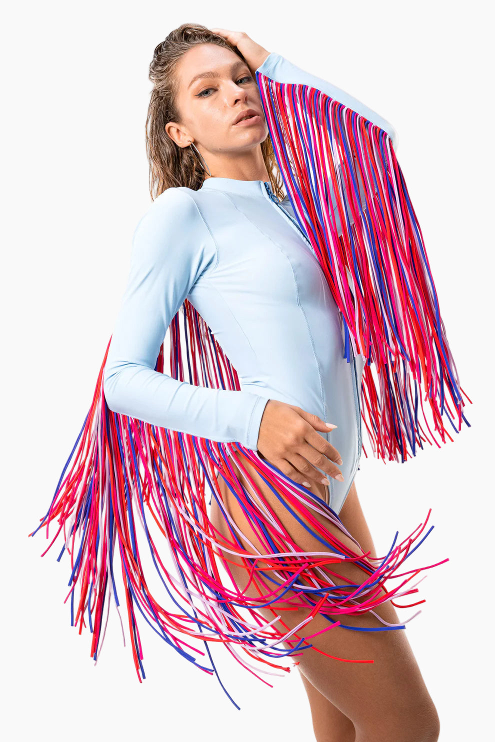Model wearing a blue bodysuit with pink fringe