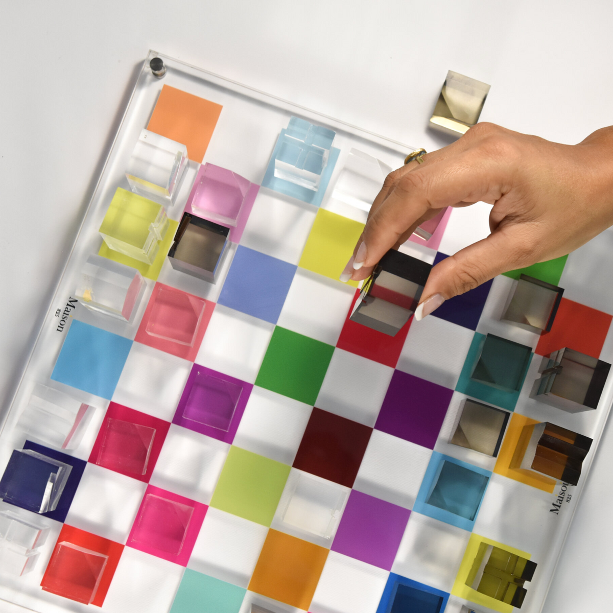 Color swatch chart with a hand pointing to different colors on a white background