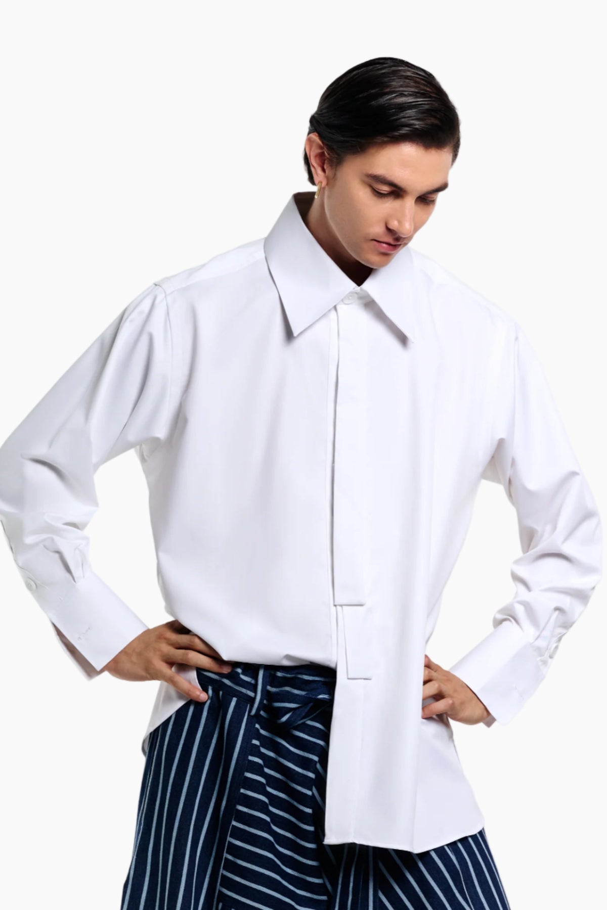 Person wearing a white shirt with a plain background