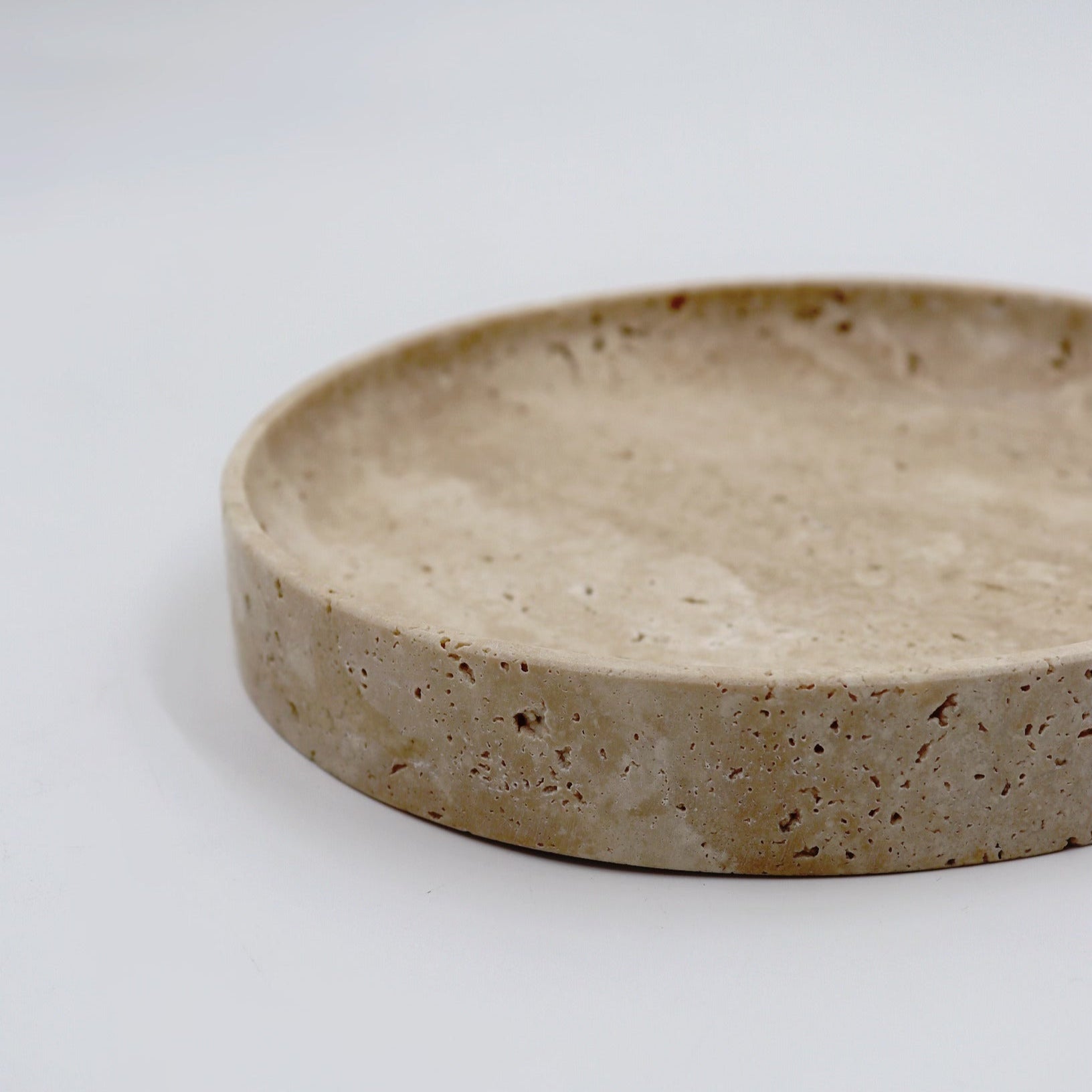 Round concrete tray on a light gray background