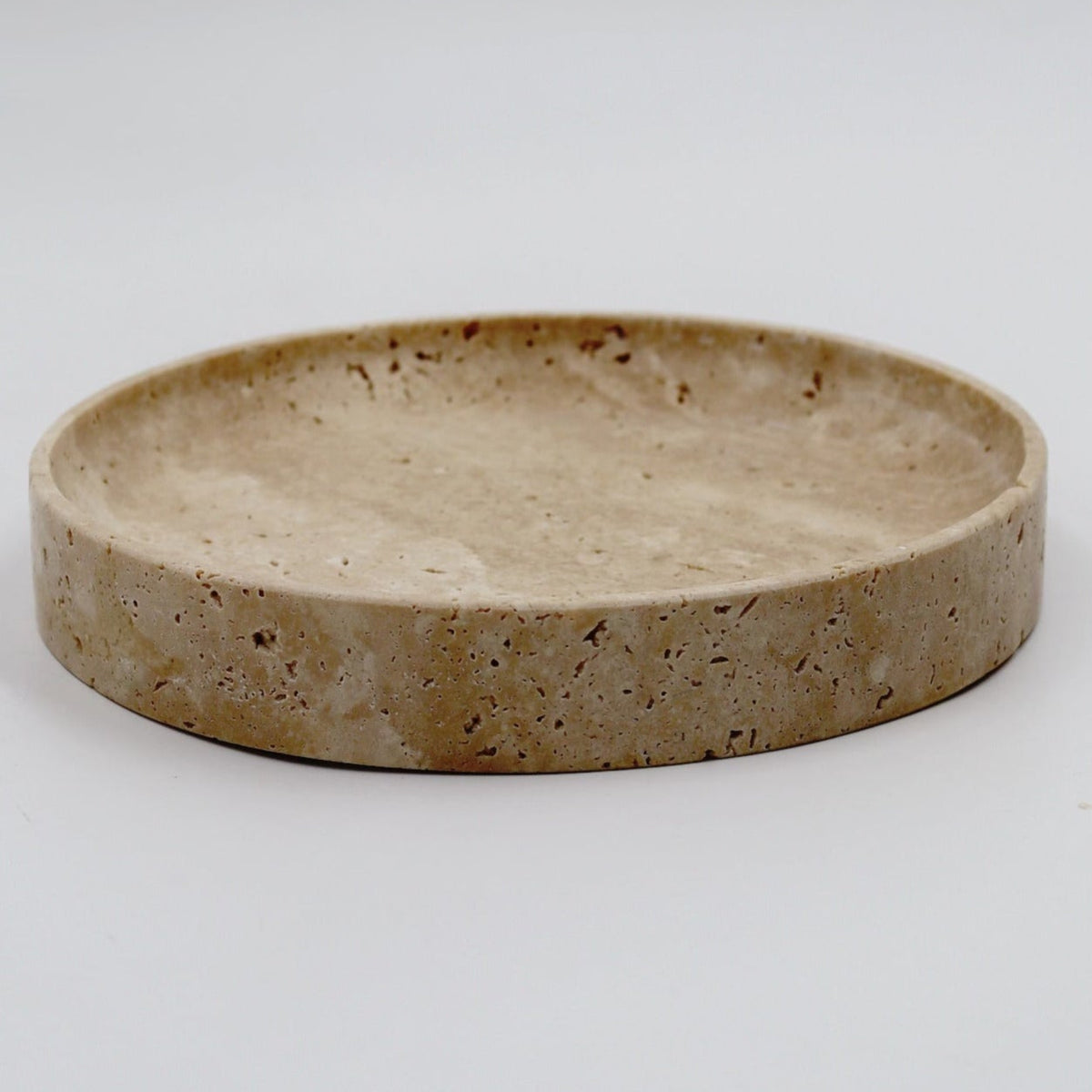 Round ceramic dish with a textured surface on a white background