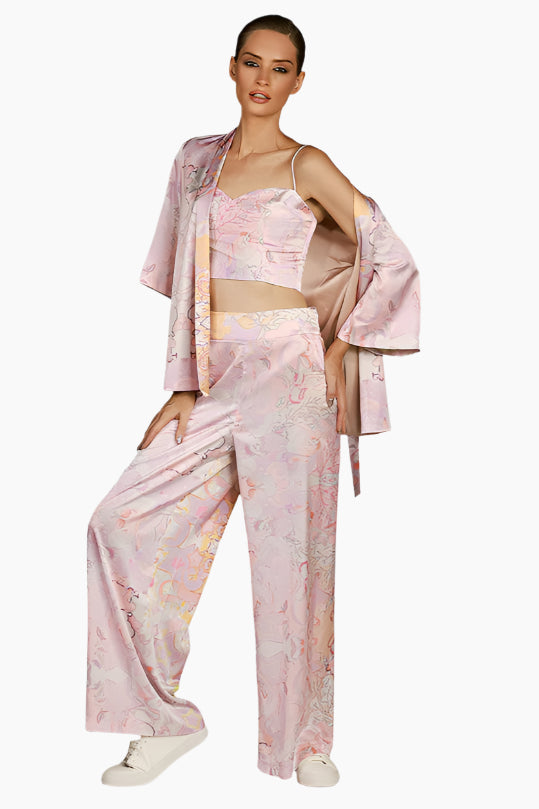 Woman wearing a pink floral outfit skirt, top and kimono