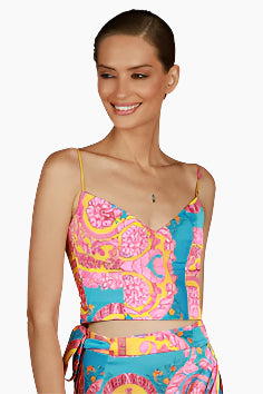 Woman wearing a colorful patterned top and skirt