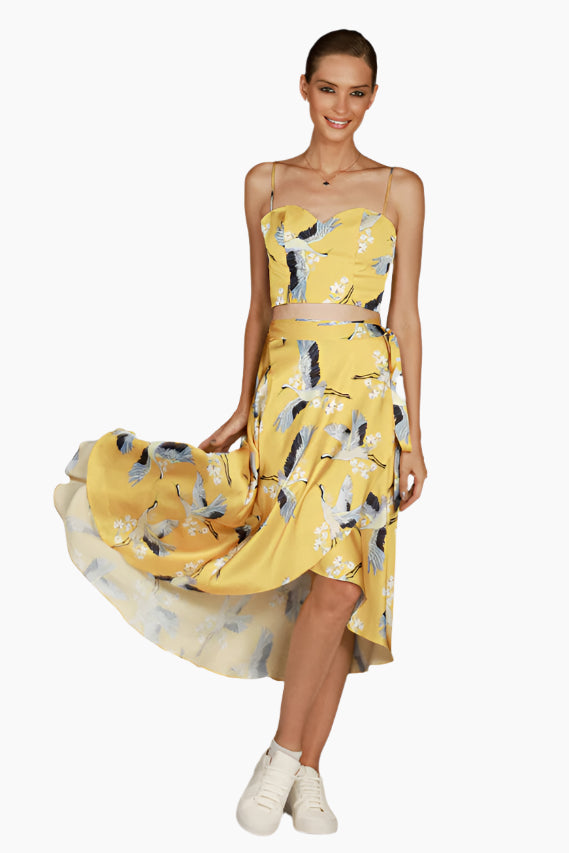 Model wearing a yellow floral dress, Flow wrap design with matching top