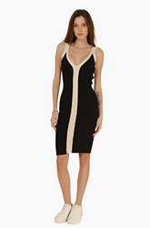 Woman wearing a black and beige dress