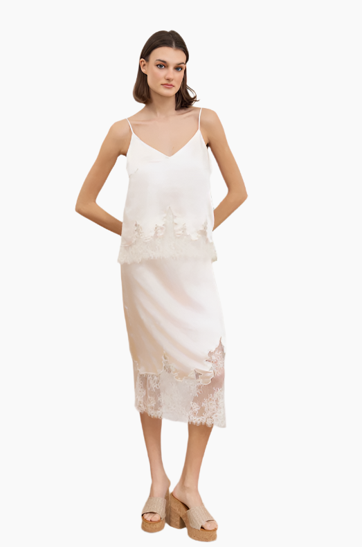 Woman wearing a white slip dress with lace details