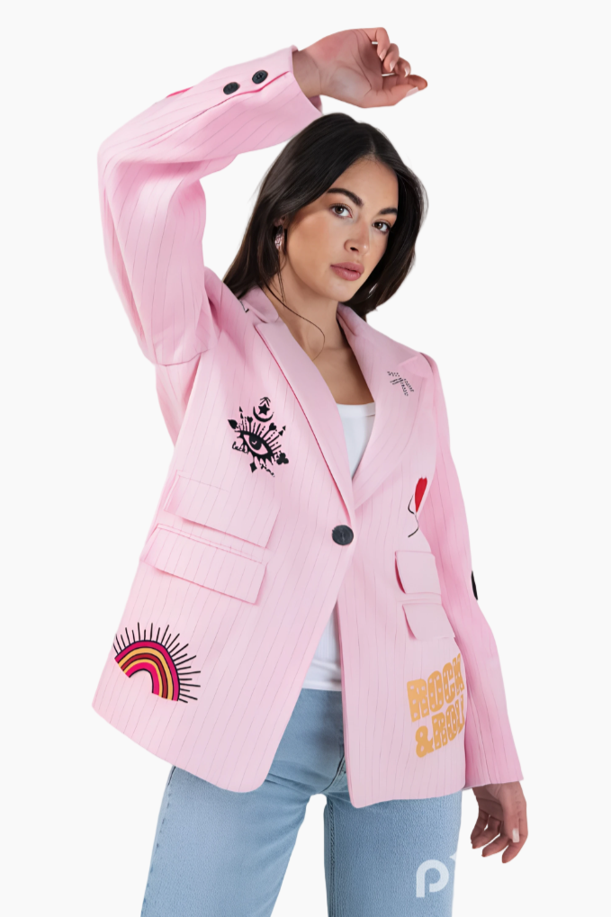 Person wearing a pink blazer with colorful designs on a white background