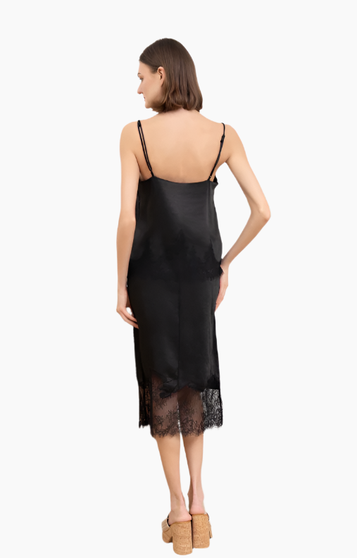 Woman wearing a black slip dress with lace hem