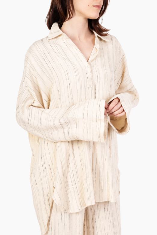 Woman wearing a beige ribbed sweater on a white background