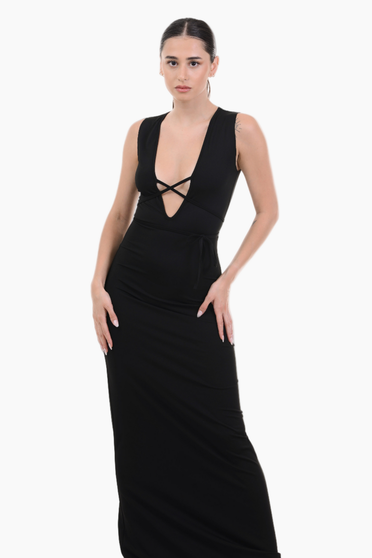 Woman wearing a black sleeveless dress with a plunging neckline