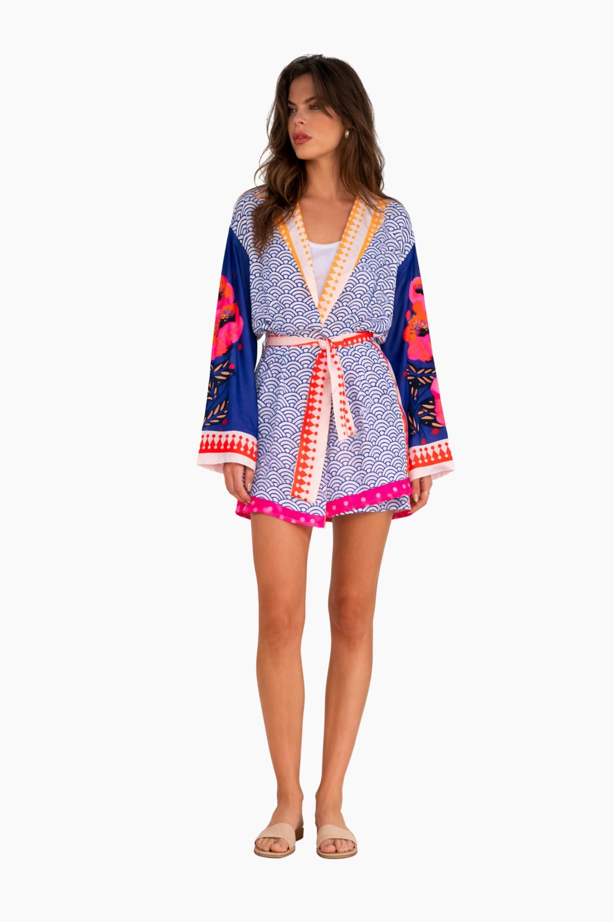 Woman wearing a colorful patterned kimono-style robe on a white background