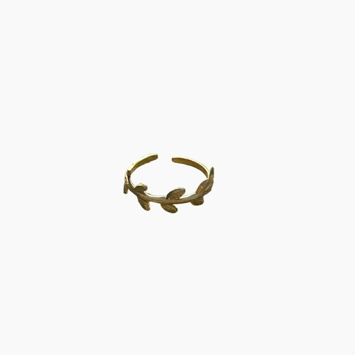 Gold ring with leaf design on a white background