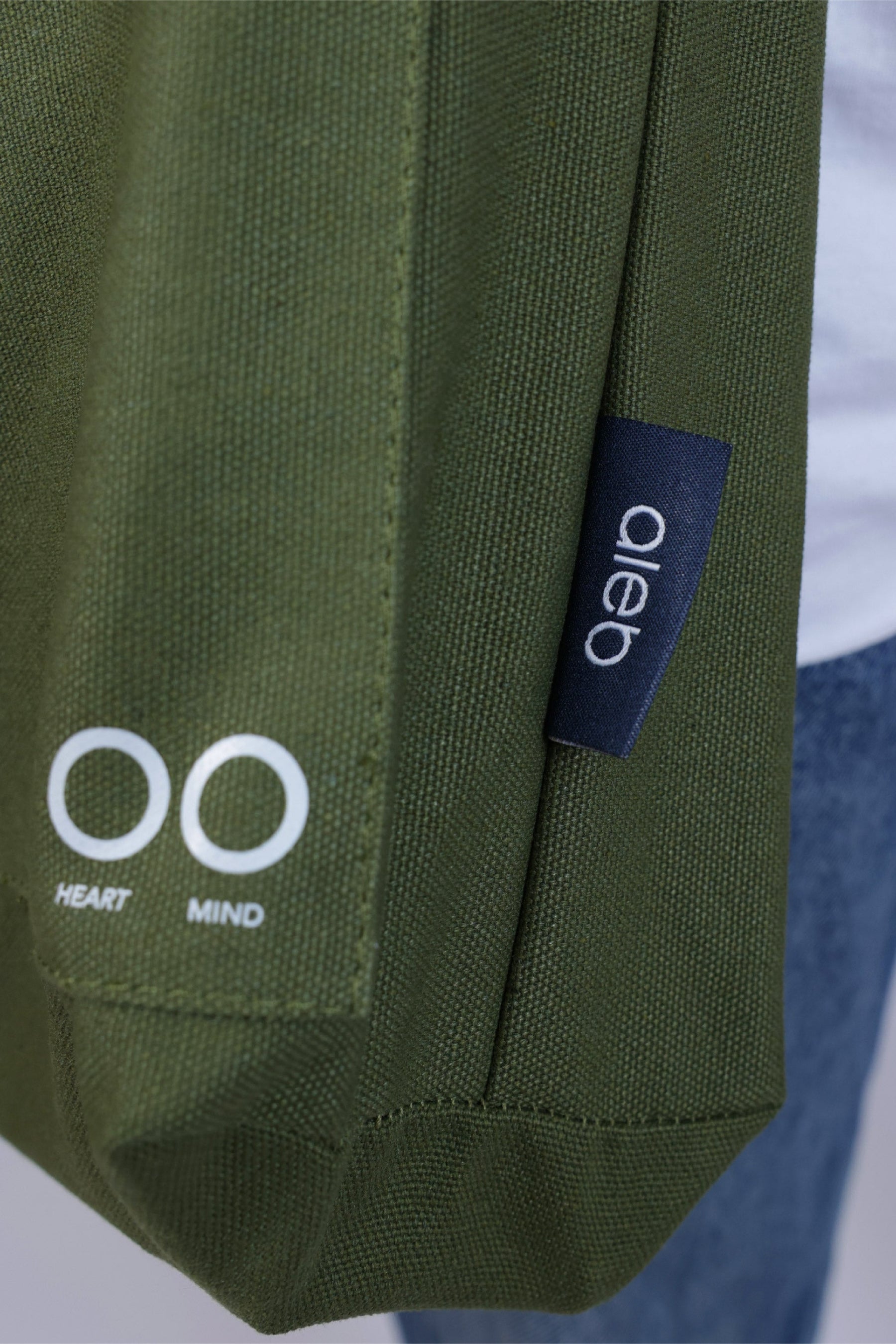 Green fabric with a logo and text on a white background