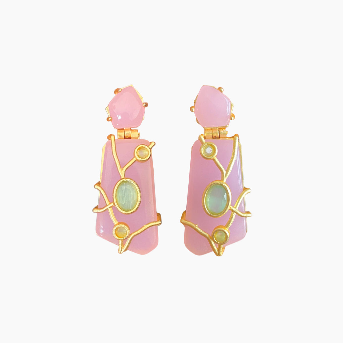 Pink earrings with gold accents on a white background