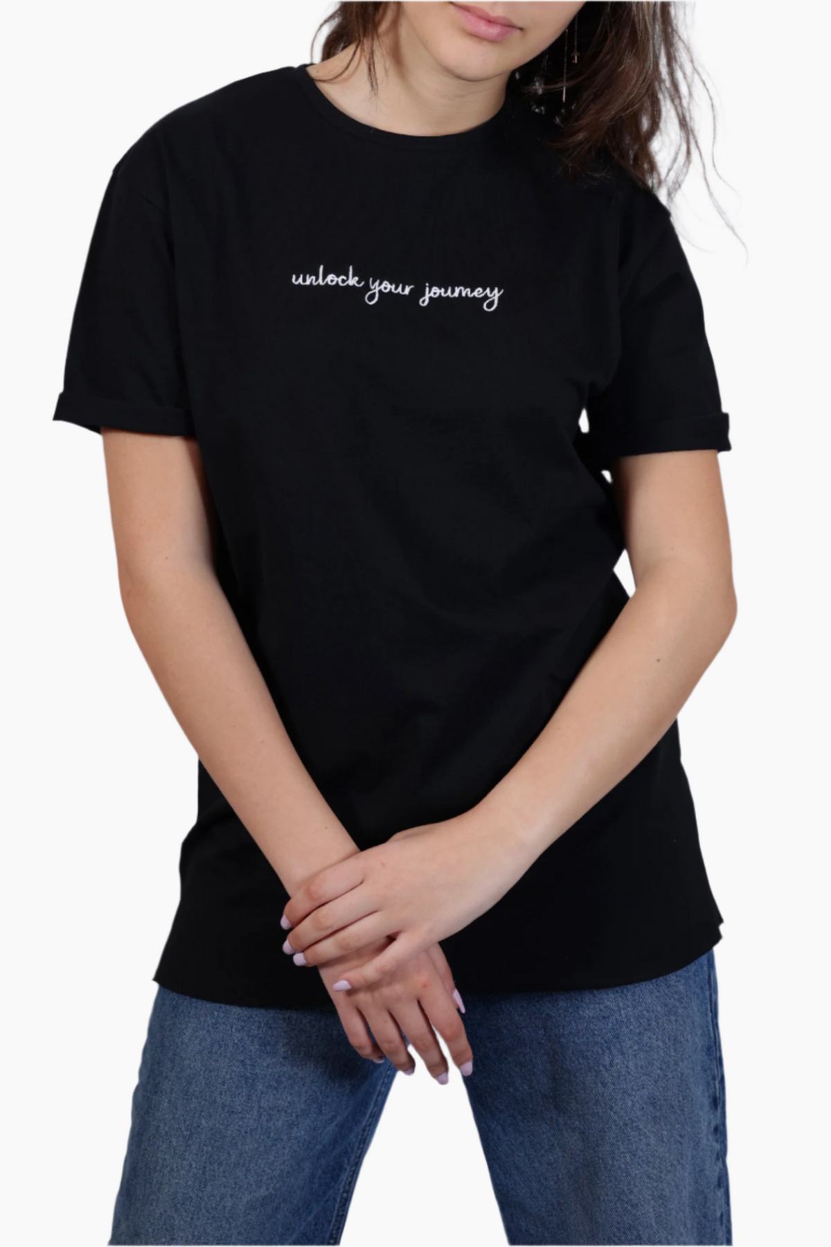 Person wearing a black t-shirt with 'unlock your journey' text , Unisex