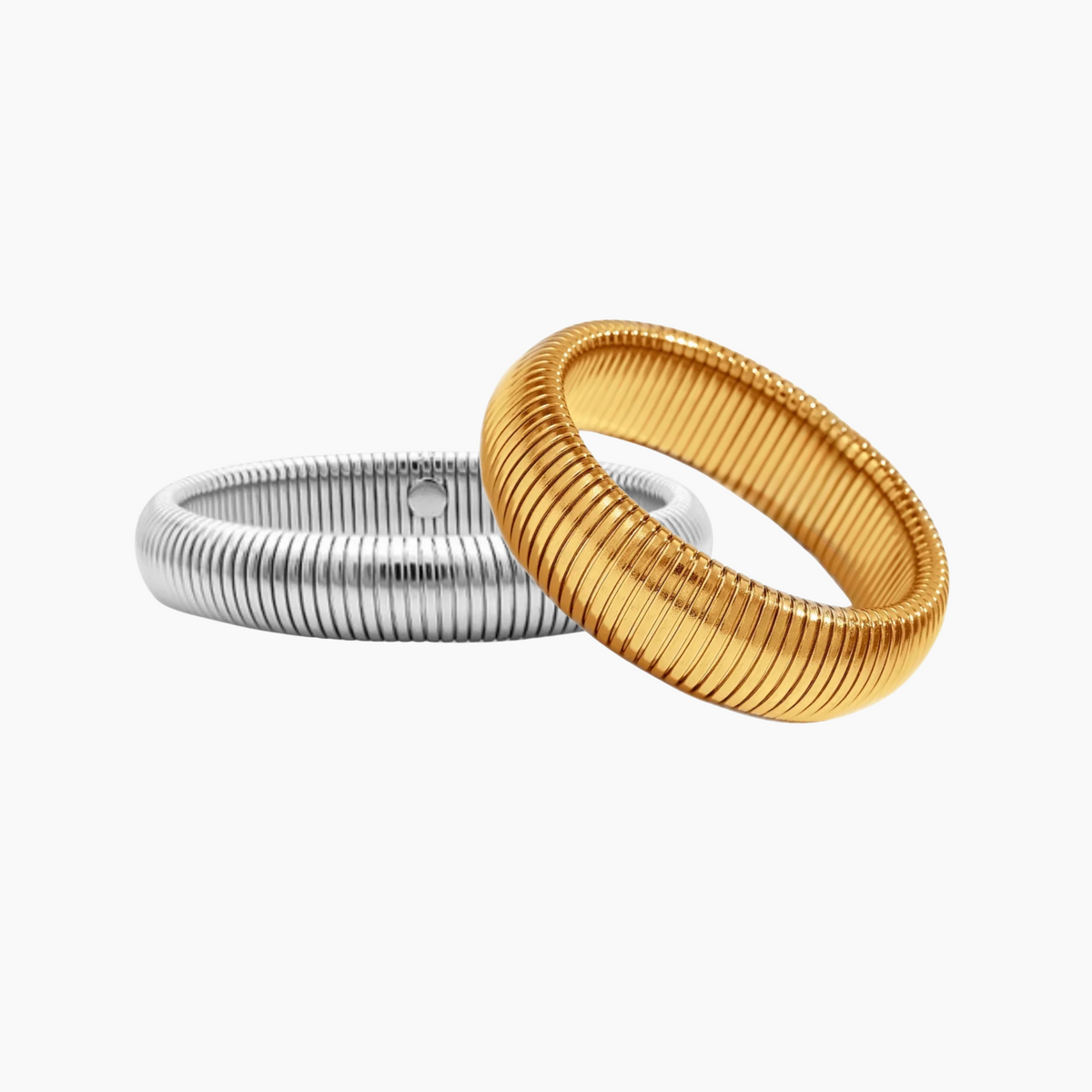 Two rings, one gold and one silver, on a white background