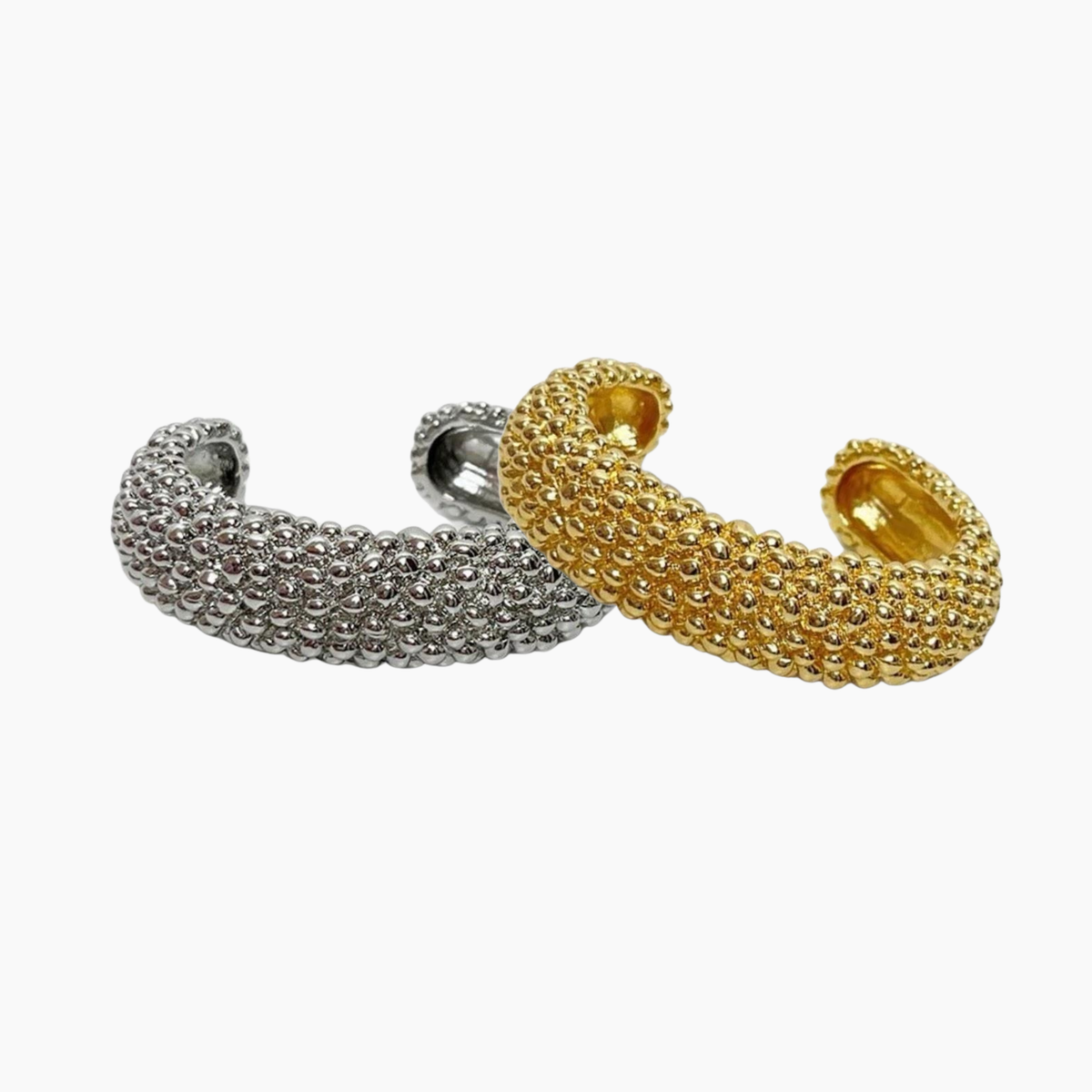 Gold and silver beaded cuff bracelets on a white background