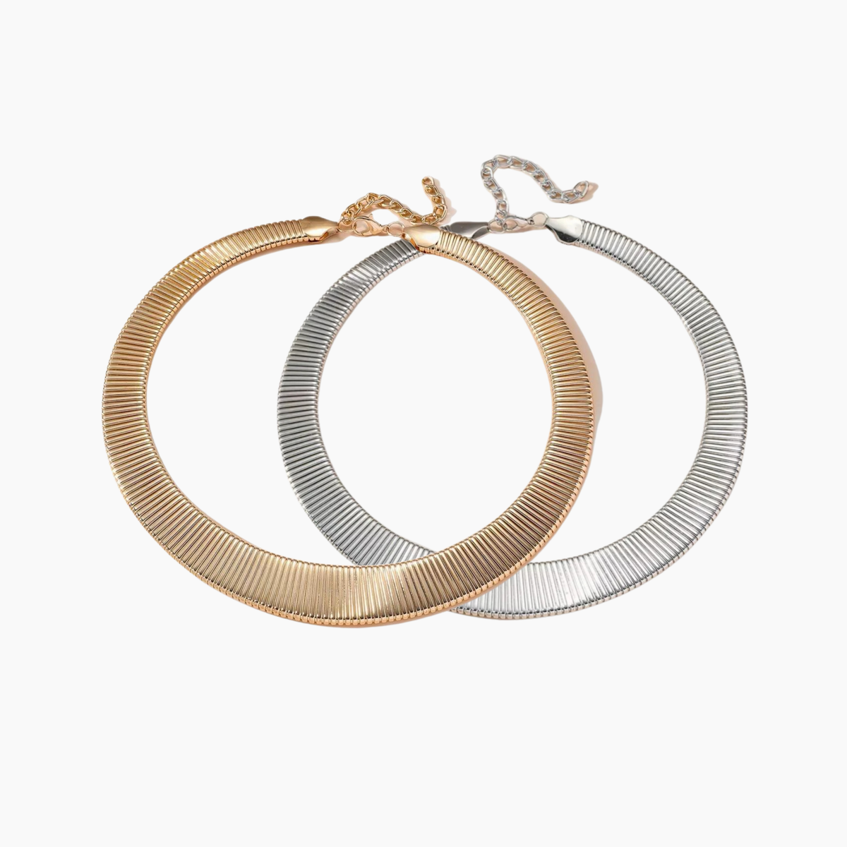 Two hoop earrings, one gold and one silver, on a white background