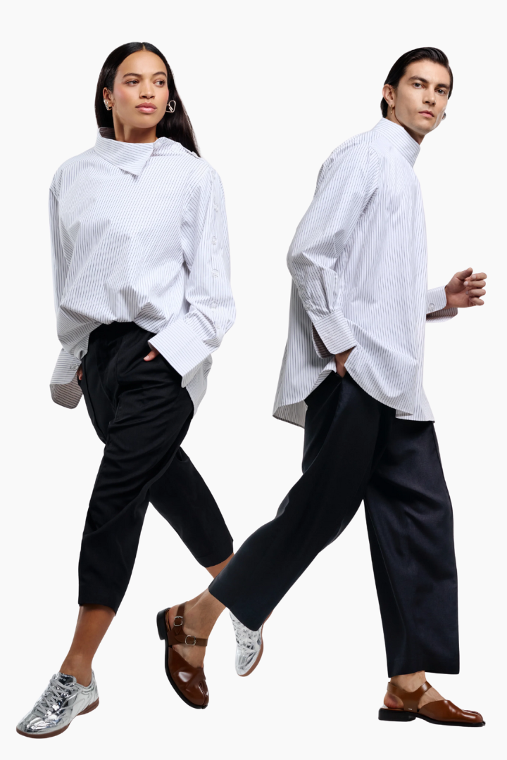 Two people wearing white shirts and black pants on a white background