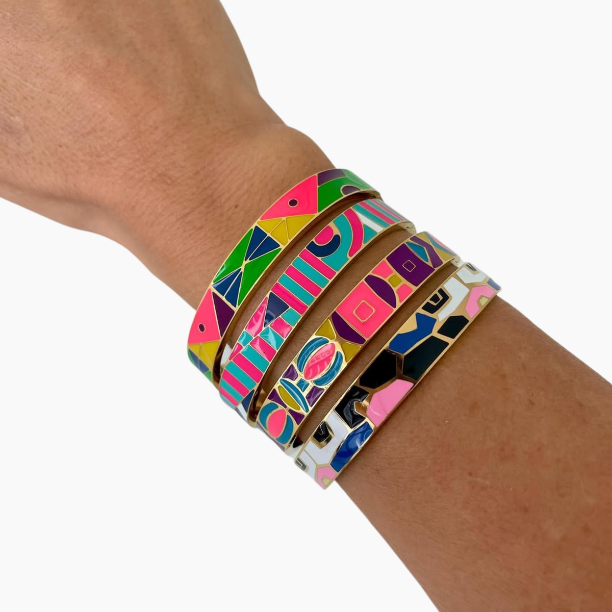 Colorful patterned bracelets on a wrist against a white background