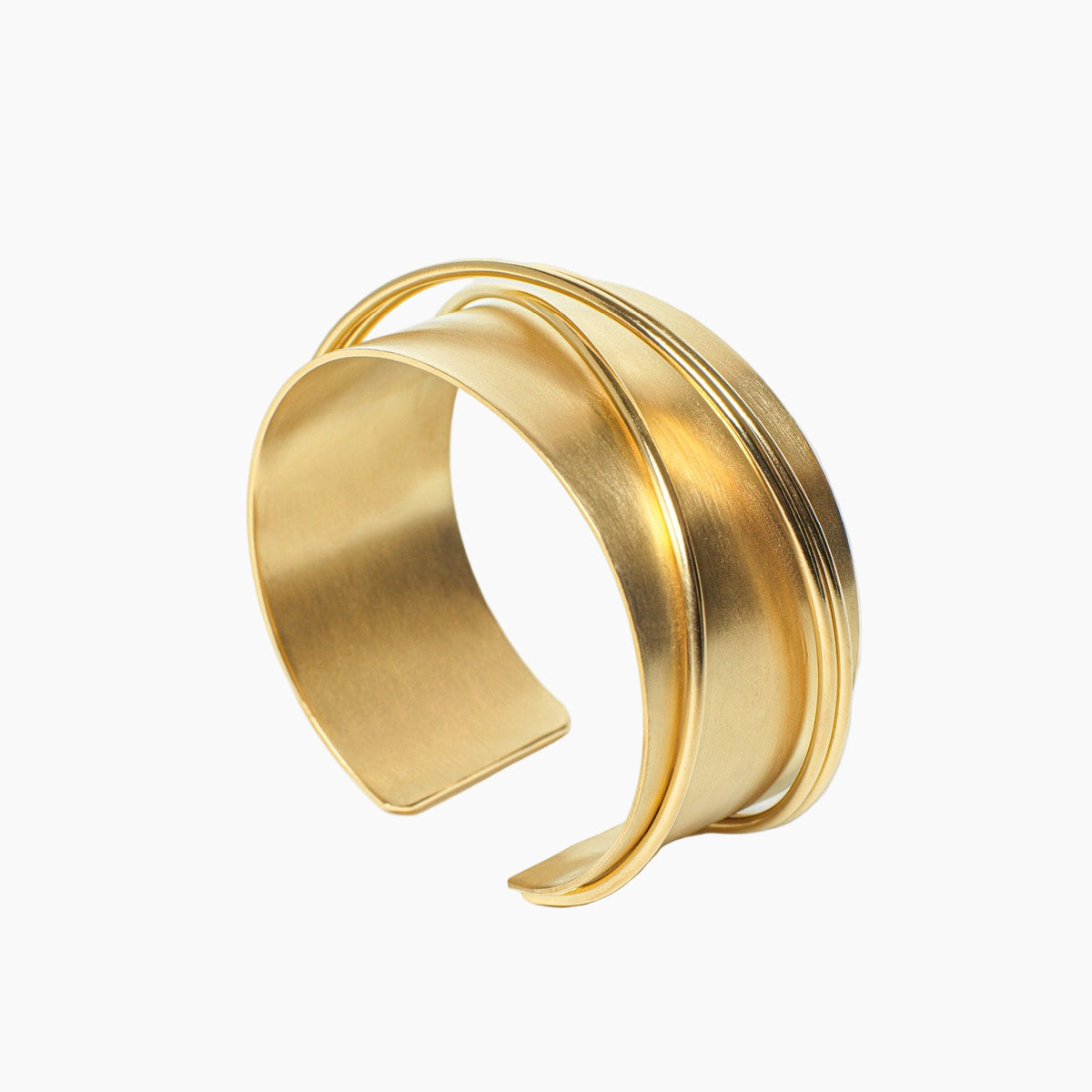 Gold bracelet on a light gray background