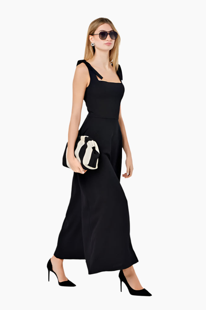 Woman wearing a black lace dress Fitted corset-like ankle-length dress with adjustable straps, a flared skirt, and a middle back zipper.