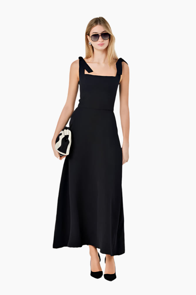 Woman wearing a black lace dress Fitted corset-like ankle-length dress with adjustable straps, a flared skirt, and a middle back zipper.