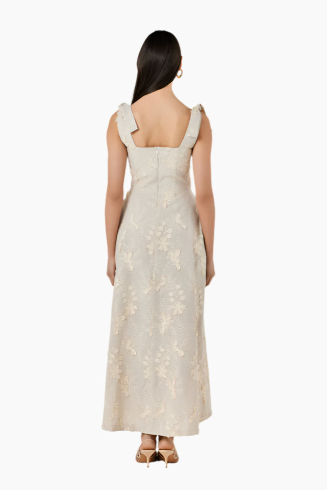 Woman wearing a beige lace dress Fitted corset-like ankle-length dress with adjustable straps, a flared skirt, and a middle back zipper.