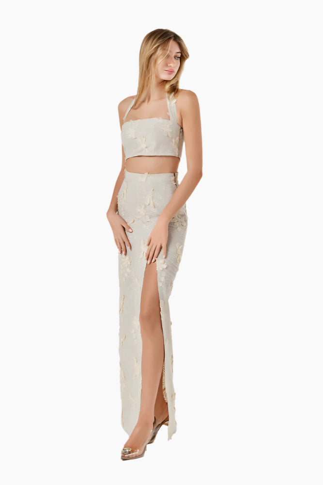 Woman wearing a white lace outfit , Halter-neck cropped top with a side zipper.