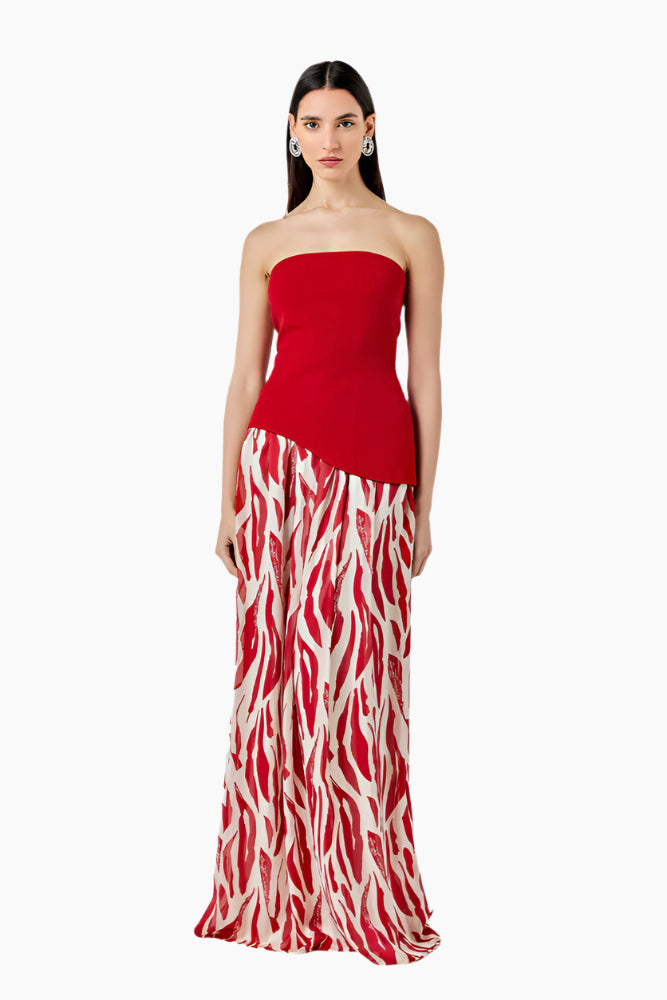 Woman wearing a strapless red dress with a zebra print skirt. Strapless top with an asymmetrical hem and a side zipper. Styled with a gathered skirt with a waistband and invisible zip fastening.