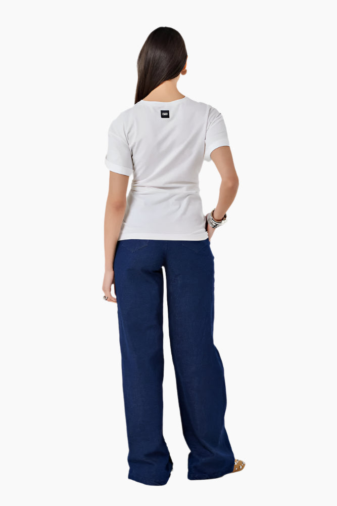 Person wearing a white t-shirt and blue pants