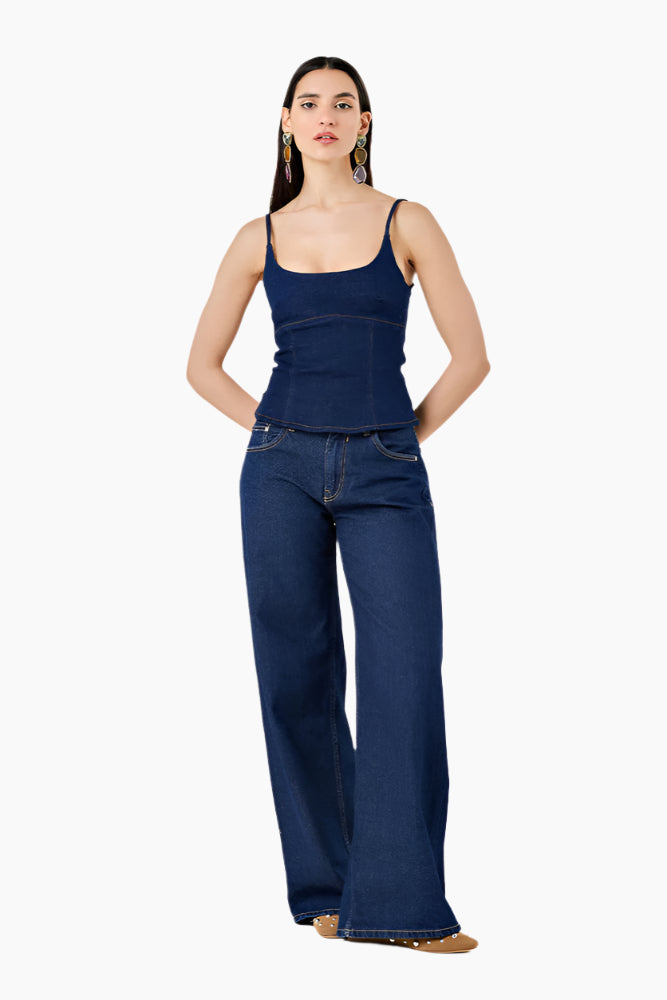 Woman wearing a blue tank top and jeans