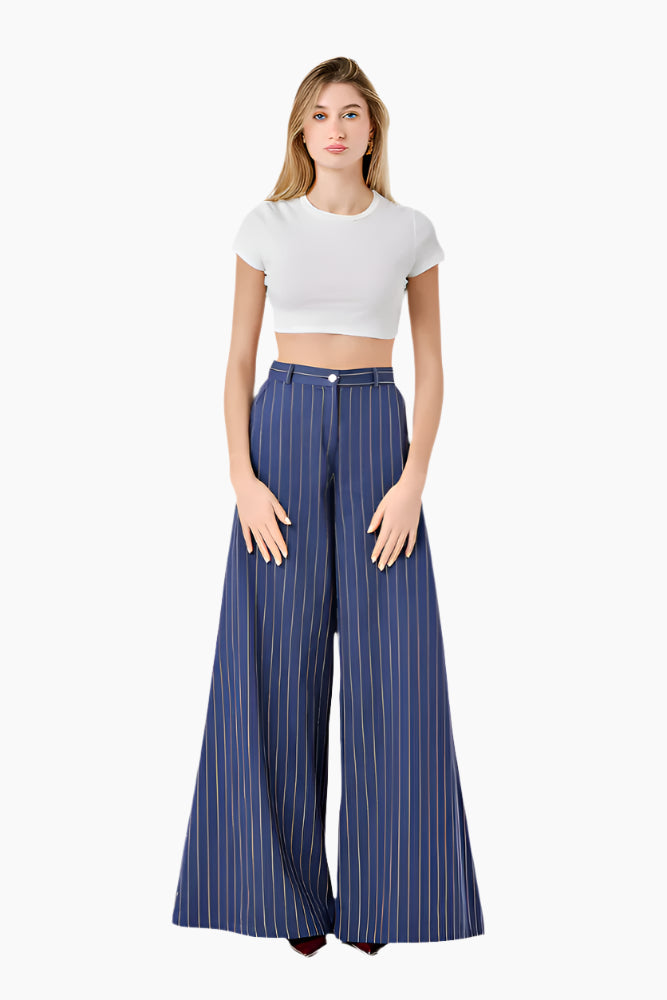Woman wearing a white crop top and blue striped wide-leg pants. High-waist trousers with a wide-leg design and a front zip fly.