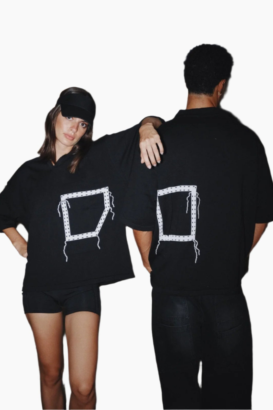 Two people wearing black t-shirts with white graphic designs
